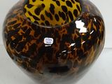 a glass vase with a leopard print design on it