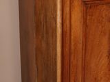 a wooden cabinet with plates on top of it