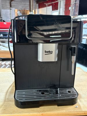 an image of a black coffee machine sitting on top of a wooden table