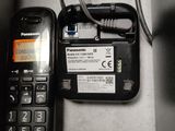 a cell phone sitting next to a charger on a table