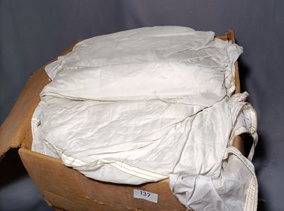a cardboard box with a bag of pillows on top of it