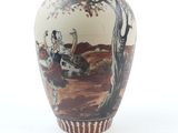a vase with a picture of a man riding a horse on it