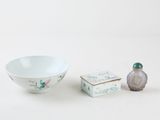 a small bowl and a small box sitting next to each other