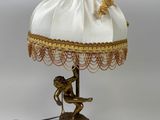 a lamp that is sitting on a table with a lamp shade on it