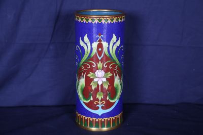 un vase bleu orné d'un motif rouge et vert