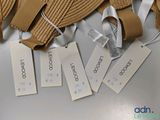 several tags on a hat that are on a table