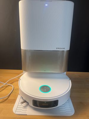 an air purifier sitting on top of a wooden table next to a mouse