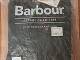 a barbour t - shirt wrapped in plastic on a table