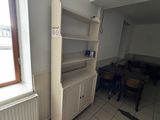 a room with a refrigerator and a table in it