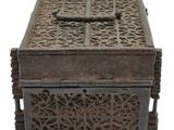 an old wooden box with a cross on the top of it