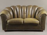 leather loveseat with scalloped arms and curved arms
