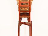 a tall wooden stand with a clock on top of it