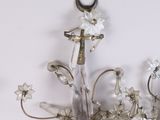 a glass chandelier with flowers and a crescent on the top