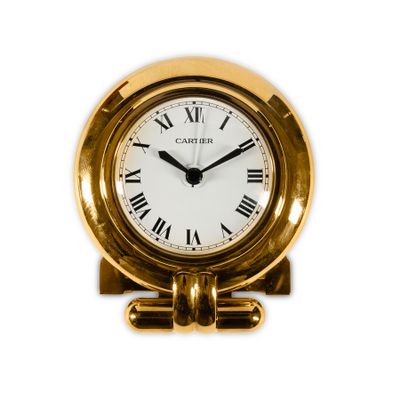 a gold clock with roman numerals on the face