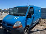 a blue van parked next to a boat on the water