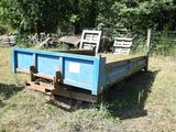 a blue truck that is sitting in the grass