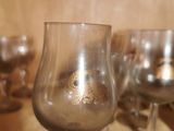 several empty wine glasses are lined up on a table