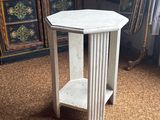 a small white table with a shelf on top of it