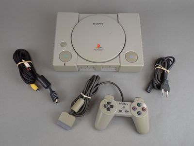 a video game console with two controllers and a charger