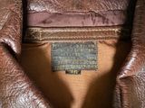 an image of a close up of a leather jacket with a label on it