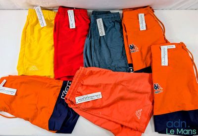 many different colors of shorts on a white surface
