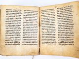 an open book with chinese writing on it sitting on top of a table