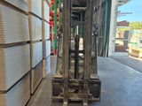 a forklift in the middle of a warehouse filled with boxes