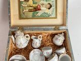 a box with a tea set in it on a table