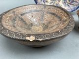 a bowl and a bowl sitting on a table next to each other