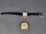 une photo représentant une montre et un bracelet de montre posés sur une table