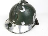 a green helmet with holes on it sitting on a white surface