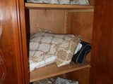 a closet with a lot of clothes on the shelves