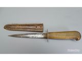 two knives are sitting next to each other on a table