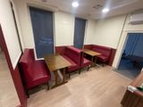 a room with red couches and tables in it