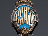 an image of a silver and blue badge with a crown on it