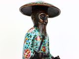 a figurine of a man riding a horse with a hat on his head