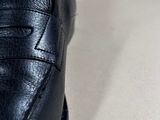 a close up of a pair of black shoes on a table