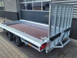 a truck with a trailer attached to it parked on the side of the street
