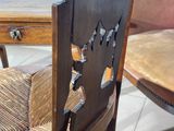 a close up of a wooden chair with a wooden seat