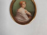 miniature portrait of a woman in a white dress in a gold frame