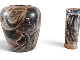 deux vases posés l'un à côté de l'autre sur une surface blanche