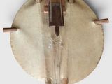 an old drum with wooden sticks on a white surface
