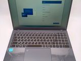 a silver laptop with a blue button on the keyboard