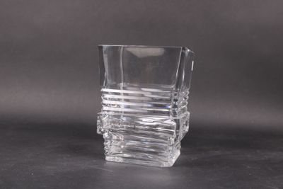 a shot of a glass on a table with a black background