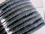 a person holding a bunch of black and white strips
