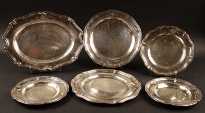 six silver plated dishes on a black background