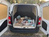 a white van that has a lot of boxes in the back of it
