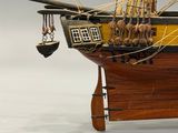 a wooden model of a ship on display on a table