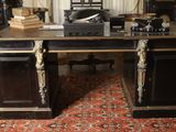 a large desk with a clock on top of it