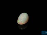 a white oplite in the dark with a black background